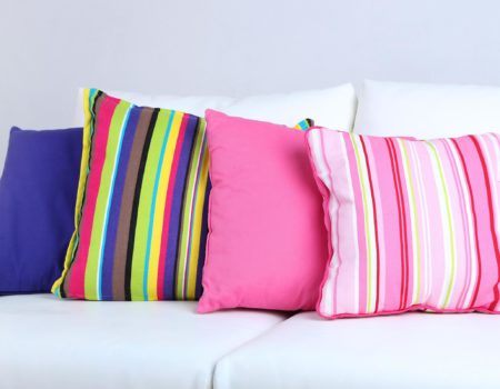 White sofa with colorful pillows in room